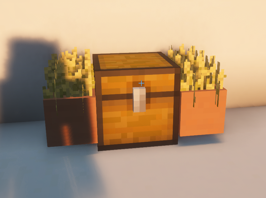 Planters of wheat either side of a chest